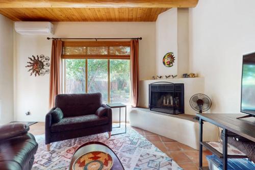 a living room with a chair and a fireplace at Casa Belleza in Taos