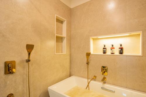 a bathroom with a shower and a tub and a sink at Villa Fleuve 6-BHK Riverfront Hideaway With Infinity Pool & Bathtub in Nerul