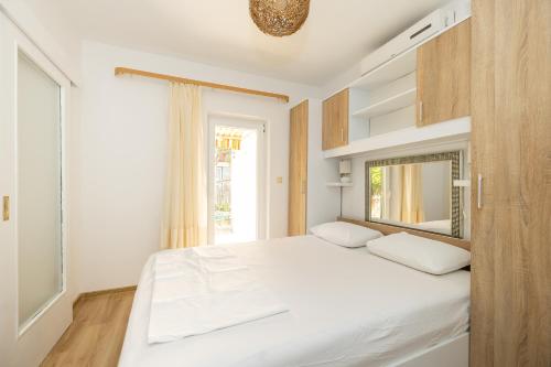 Posteľ alebo postele v izbe v ubytovaní tiho's apartments