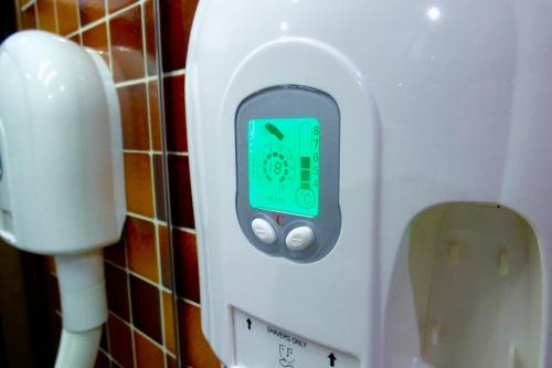 a soap dispenser in a bathroom with a phone in it at Mon Repos in Lido di Jesolo