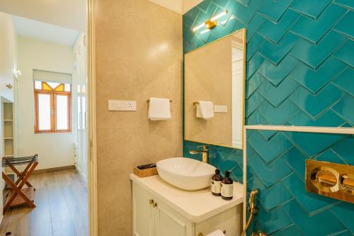 a bathroom with a sink and a mirror at Villa Fleuve 6-BHK Riverfront Hideaway With Infinity Pool & Bathtub in Nerul