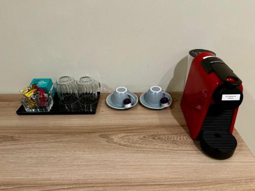 a red blender sitting on top of a wooden table at Hotel Bienal Ibirapuera UH310 in Sao Paulo