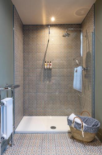 a bathroom with a shower with a tub at The George and Dragon - A Heartwood Inn in Marlow