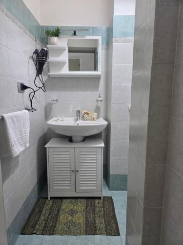 a bathroom with a sink and a mirror at SL Home in Scalea