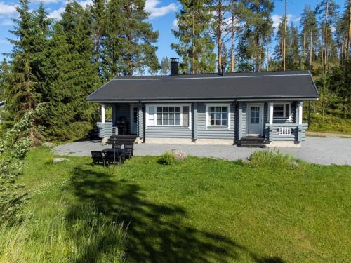 une petite maison bleue avec une cour herbeuse dans l'établissement Holiday Home Iltarusko by Interhome, à Hara