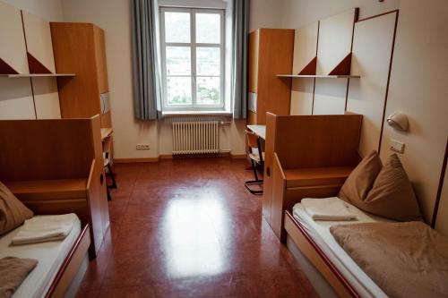a hospital room with two beds and a window at Bischöfliches Institut Vinzentinum in Bressanone