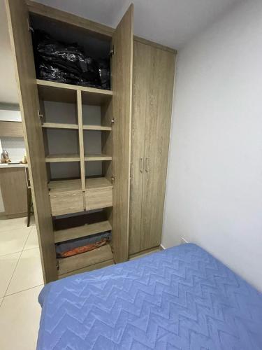 多斯克布拉达斯Apartamento cerca a Pereira的一间卧室配有木制橱柜和一张床