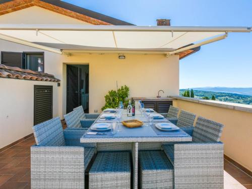 a table and chairs on the patio of a house at Apartment Sughera by Interhome in Podere Dottrina