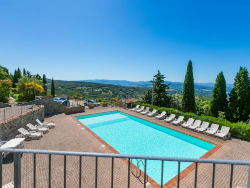 a swimming pool with chaise lounge chairs and a swimming poolvisor at Apartment Sughera by Interhome in Podere Dottrina