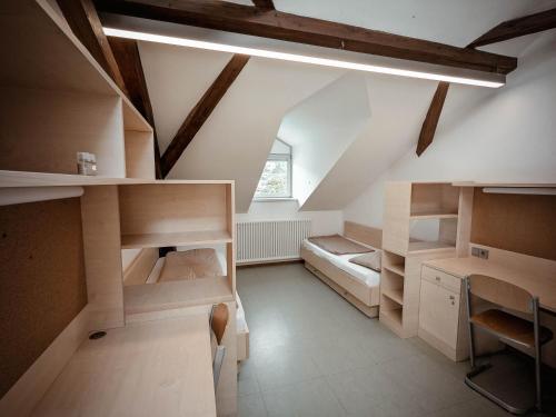 a room with wooden bunk beds and a desk at Bischöfliches Institut Vinzentinum in Bressanone