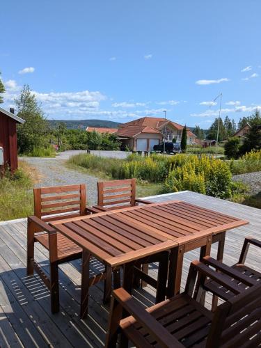a wooden table and chairs sitting on a deck at Modern Cabin by Nora Lake with AC! in Nora