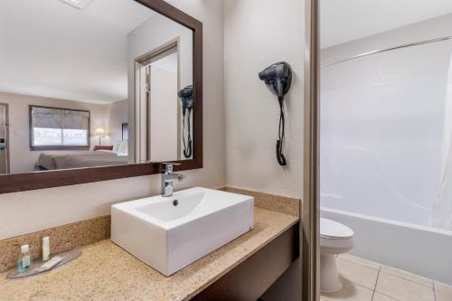 a bathroom with a white sink and a mirror at Quality Inn & Suites I-10 near Fiesta Texas in San Antonio