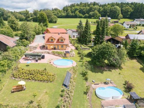 an aerial view of a house with two swimming pools at Holiday Home Chalet Toni mit Sauna by Interhome in Spiegelau