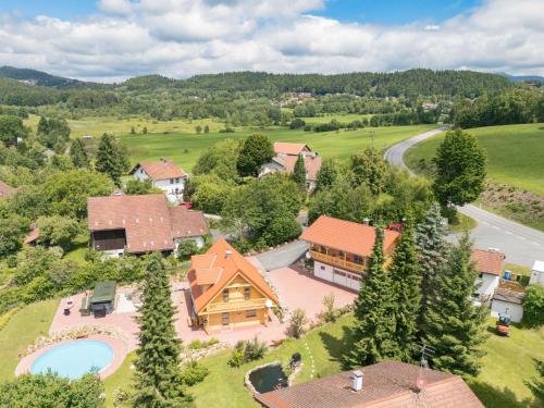 an aerial view of a home with a pool and a house at Holiday Home Chalet Toni mit Sauna by Interhome in Spiegelau