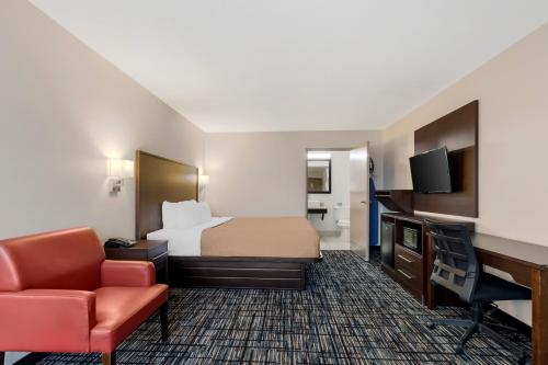 a hotel room with a bed and a desk at Quality Inn & Suites I-10 near Fiesta Texas in San Antonio