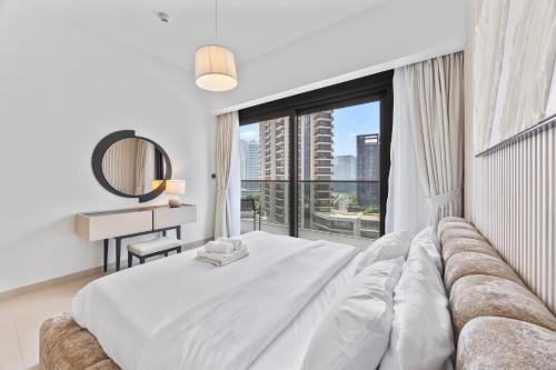 a bedroom with a large bed with a large window at Act tower-1BR near Burj Khalifa in Dubai