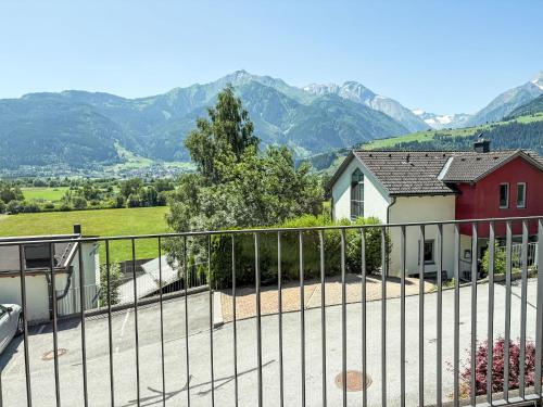 a house with a fence and mountains in the background at Apartment Emma-4 by Interhome in Dürnberg