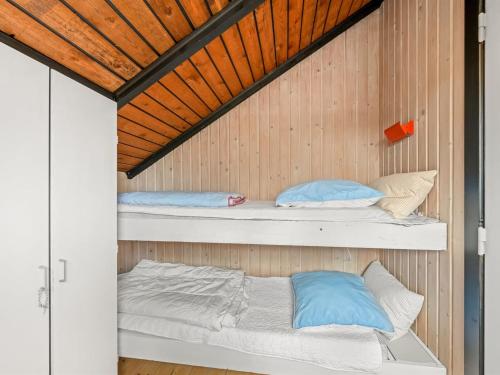 a room with two bunk beds in a cabin at Holiday Home Hildegart - from the sea by Interhome in Bjerregård