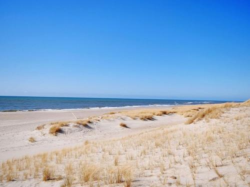 a sandy beach with the ocean in the background at Holiday Home Hildegart - from the sea by Interhome in Bjerregård