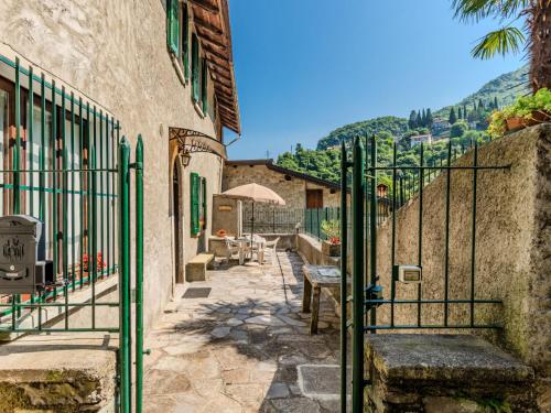 a gate to a building with a table and chairs at Holiday Home Angela by Interhome in Perledo