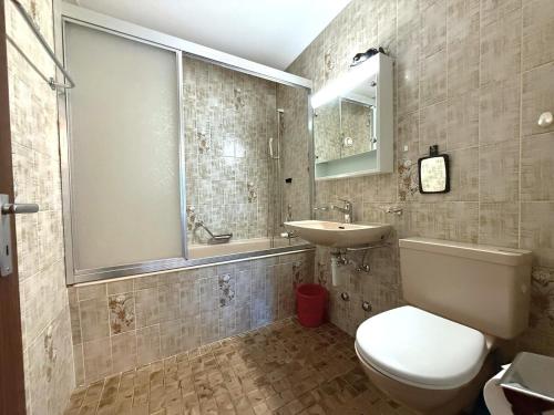 a bathroom with a toilet and a sink at Royal 51 in Leukerbad