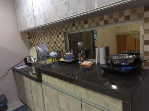 a kitchen with a counter top with a sink at MM HomeStay 82 in Kamunting