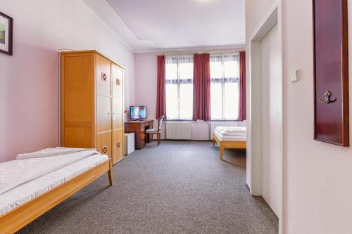 Postel nebo postele na pokoji v ubytování Hotel U Salzmannů