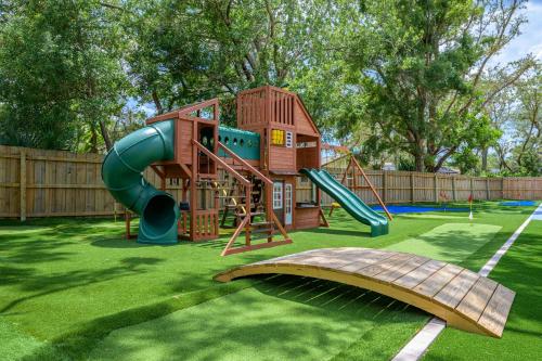 a playground with a slide and a slide at 18 Guests Pool Pickleball Volleyball in Seminole