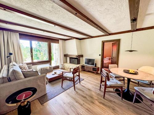 a living room with a couch and a table at Apartment Chesa Gop by Interhome in Valbella