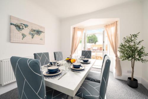 a white dining room with a table and chairs at Luxury House - Pool Table - Parking - Brand New in Little Coates