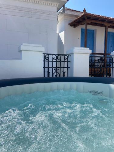 a pool of water in front of a house at Adele house in Skopelos Town