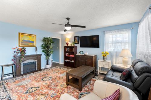 a living room with a couch and a fireplace at Swallows Nest in Kitty Hawk