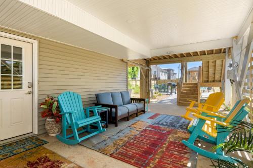 a porch with colorful chairs and a couch at Swallows Nest in Kitty Hawk