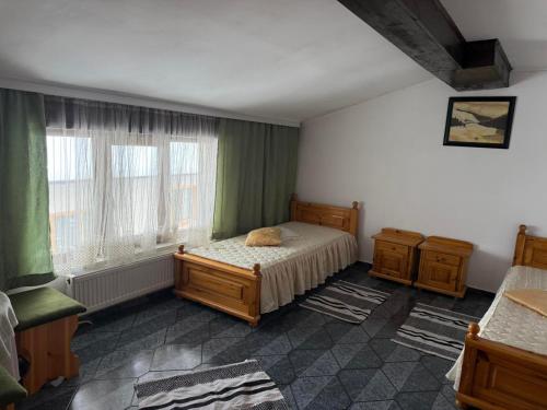 a bedroom with a bed and a window at Къща за гости Гаджо Gadjo in Bansko