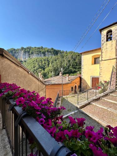 a bunch of flowers on a balcony with stairs at Casa Altolaterra in Tagliacozzo