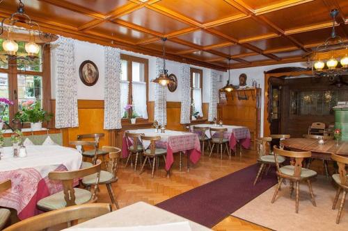 a restaurant with tables and chairs in a room at Steppacher Ferienappartements in Friedenweiler