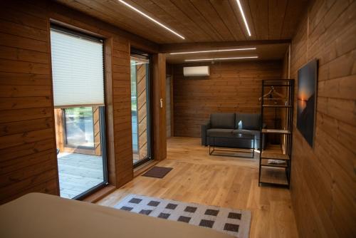 a living room with a couch and a window at Roosta Holiday Village in Elbiku