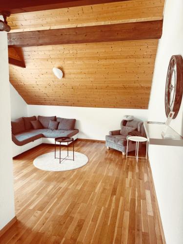a living room with a couch and a table at Schwarzwald Hotel Wiedenerhof in Wieden