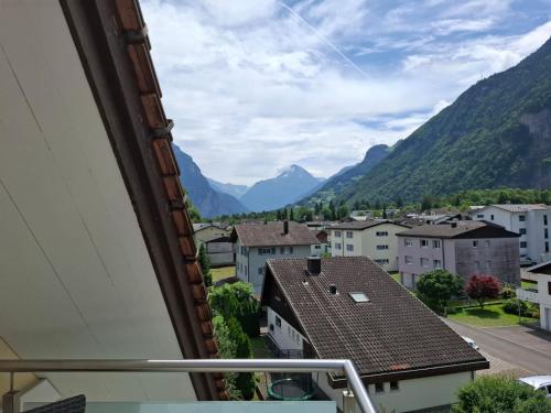 a view from a balcony of a town with mountains at Hotel & Restaurant Rössli in Seedorf