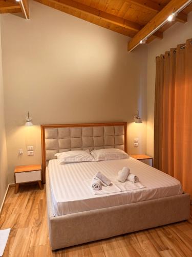 a bedroom with a large bed with towels on it at Arial Penthouse Suites in Vlorë