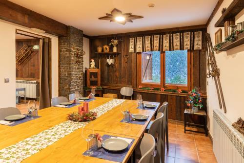 a dining room with a long table and chairs at Hotel Restaurant Camp del Serrat in Andorra la Vella