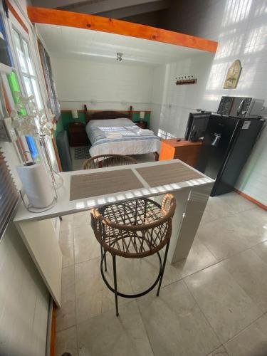 a kitchen with a desk and a bed in a room at Galpón 10 in San Martín de los Andes