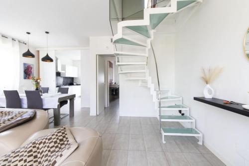 a staircase in a living room with a couch and a table at Daste Dream House in Bergamo