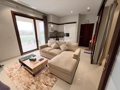 a living room with a couch and a table at Hawana luxury 1BedRoom apartment in Salalah