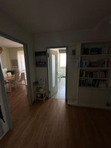 an empty living room with a door open to a dining room at Panoramico Appartamento VISTA MARE in Rimini