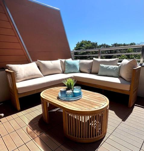 a couch and a table on a balcony at Hotel Dom Zdrojowy Resort & SPA - Destigo Hotels in Jastarnia