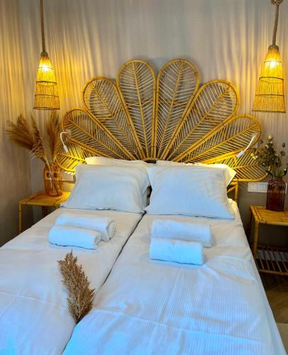 a large white bed with two towels on it at Hotel Dom Zdrojowy Resort & SPA - Destigo Hotels in Jastarnia
