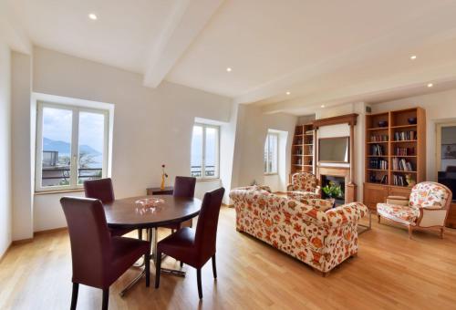 a living room with a table and chairs at Rouvenaz Appartements in Montreux