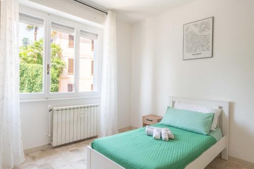 a bedroom with a bed with two towels on it at La Darsena Front lake apartment in Maccagno con Pino e Veddasca