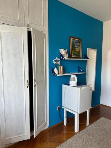 a room with a blue wall and a white door at Villa Nena in Herceg-Novi
